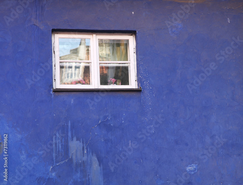 Small od window in the old blue building.