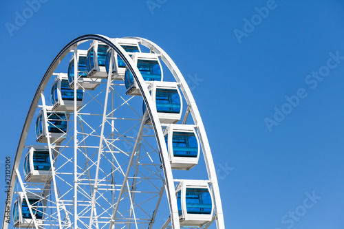 Ferris wheel over clear blue sky