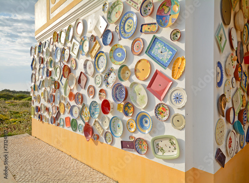 Wall with colorful hand painted plates, Algarve Portugal