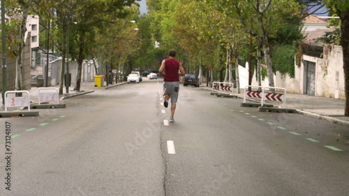 Wallpaper Mural Man jogging alone on the road, slow motion shot, steadycam shot Torontodigital.ca