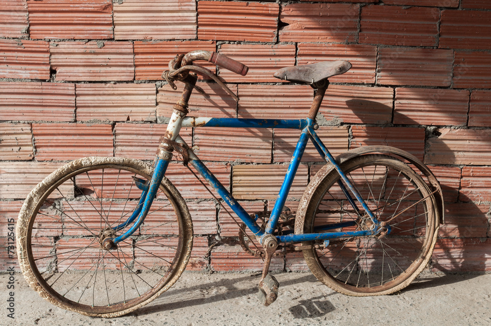 Antique or retro rusty bicycle in brick wall background