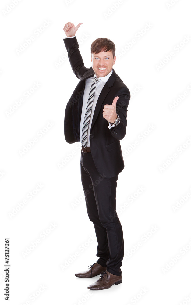 Smiling Young Businessman Gesturing Thumbs Up Smiling Young Businessman Gesturing Thumbs Up