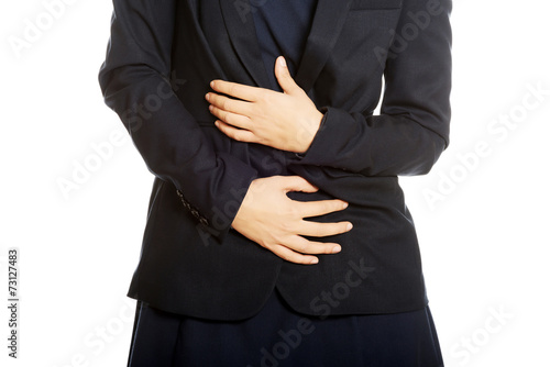 Businesswoman with stomach ache © Piotr Marcinski