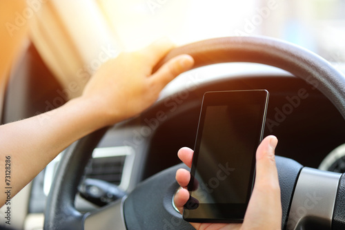 woman driver hands use cellphone driving a car
