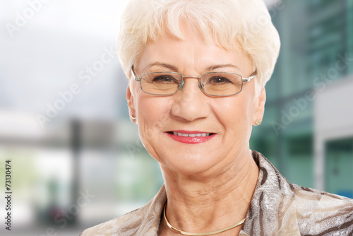 Portrait of an old lady in eyeglasses.