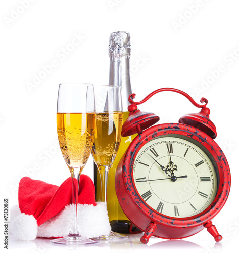 Two champagne glasses, santa hat, bottle and clock