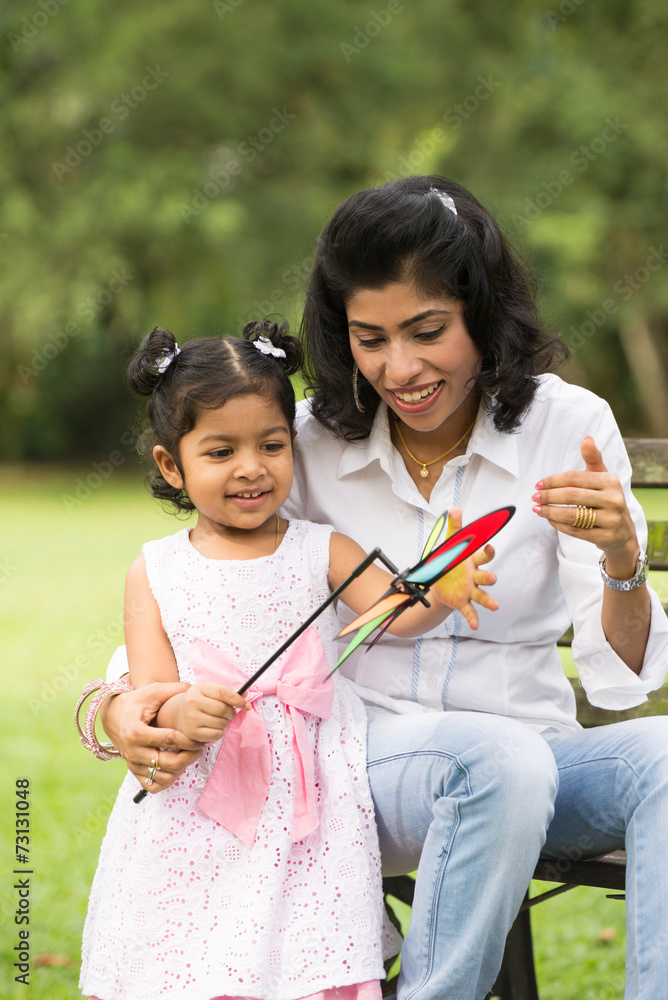 Happy Indian mother and daughter playing in the park. Lifestyle Happy Indian mother and daughter playing in the park. Lifestyle