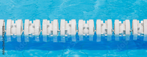 Closeup of white lane rope in swimming pool for competitions.