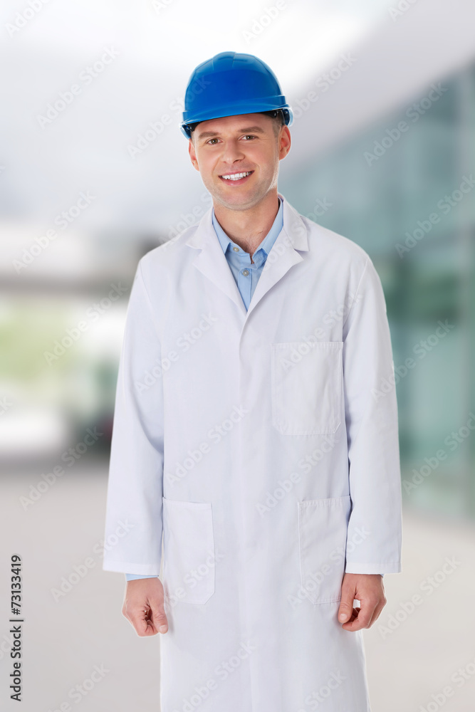 Man in a lab coat and helmet