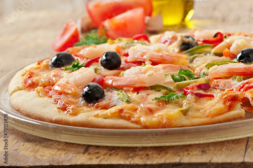 Pizza with shrimp, salmon and olives