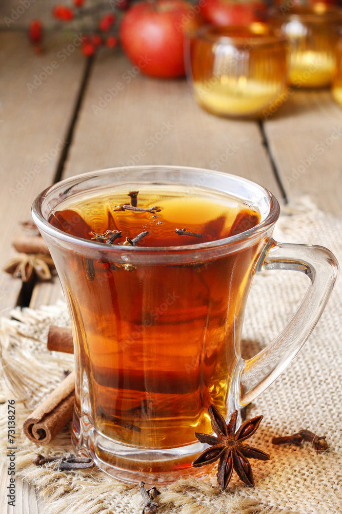 Glass of hot steaming tea among christmas decorations Glass of hot steaming tea among christmas decorations