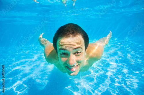 Close up view happy man swimming underwater