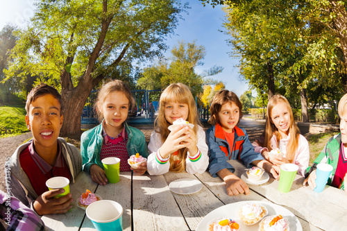 Children diversity drinking tea and eat outside