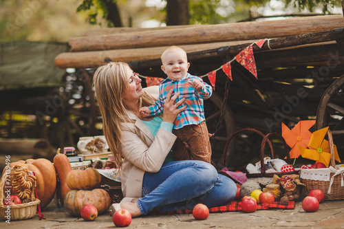 Mother and son playing in the yard of his house in the village photo