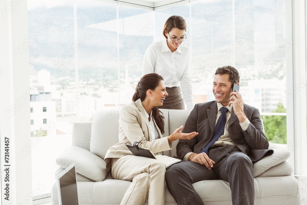 Business people in discussion in living room Business people in discussion in living room