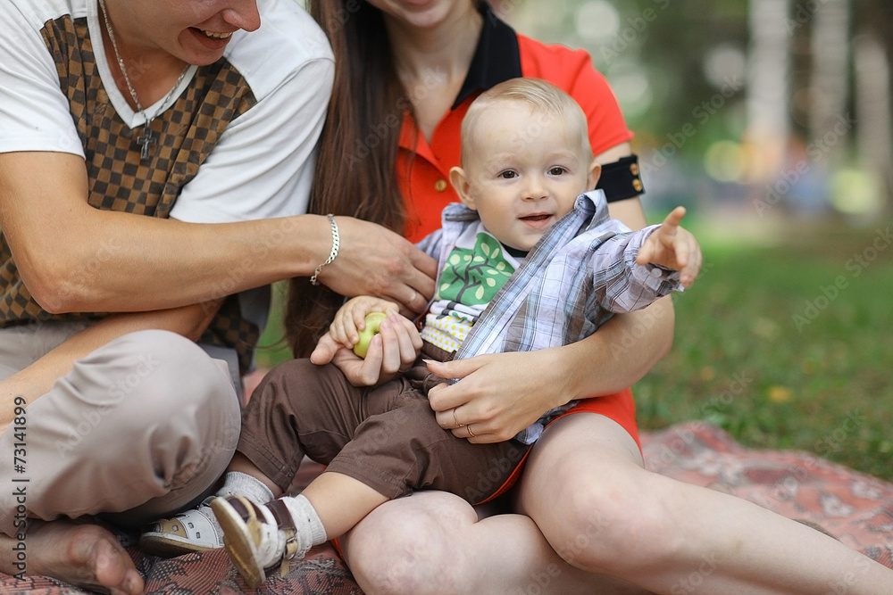 young family with a child in a summer park young family with a child in a summer park