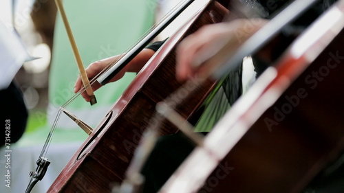 Two Musicians Playing the Violoncello. Close-up.