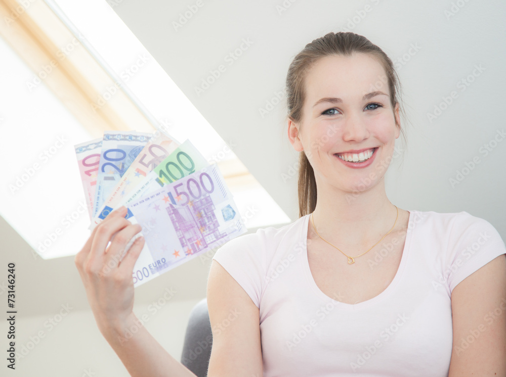 Attractive young woman holding lots of euro notes. Attractive young woman holding lots of euro notes.