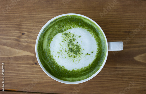 Matcha green tea latte beverage in glass.