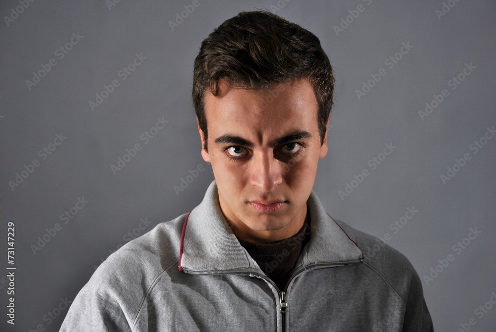 young man with angry expression young man with angry expression