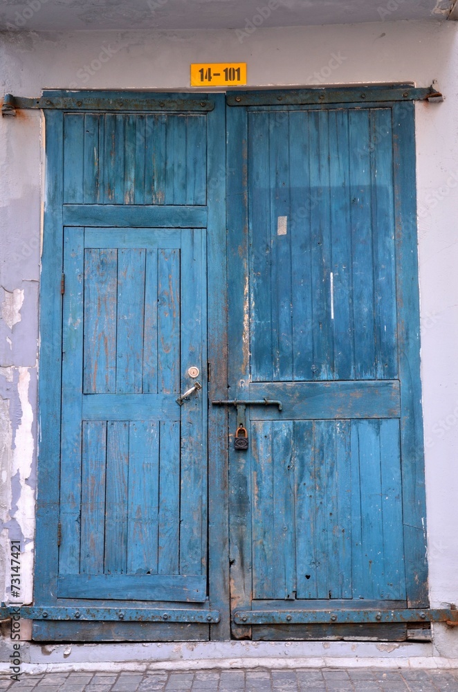 Blue wooden weathered door with padlock