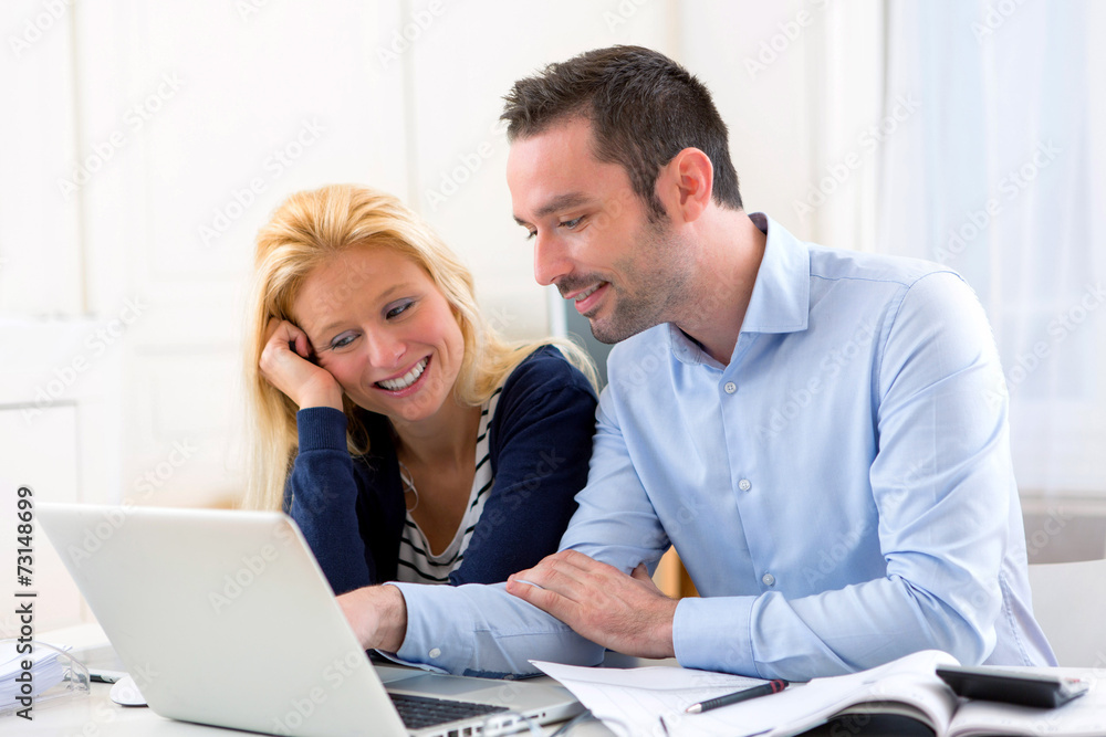 Young attractive couple using laptop at home Young attractive couple using laptop at home