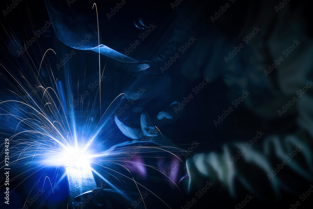 Employee welding structures with sparks - obrazy, fototapety, plakaty 