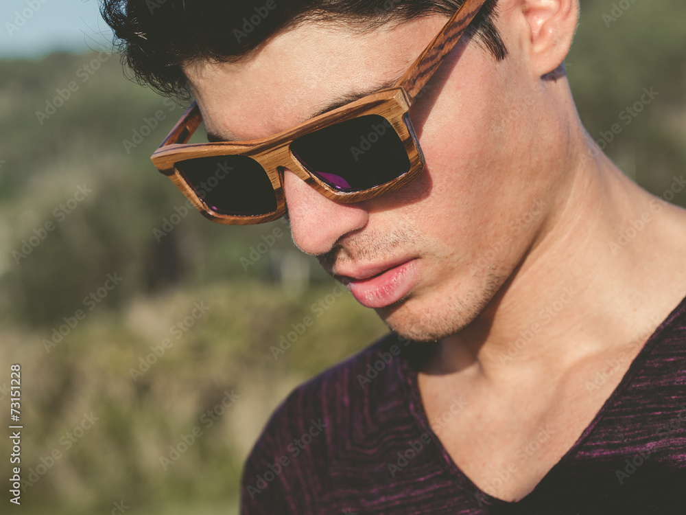 Model man portrait with wooden sunglasses outdoors Model man portrait with wooden sunglasses outdoors