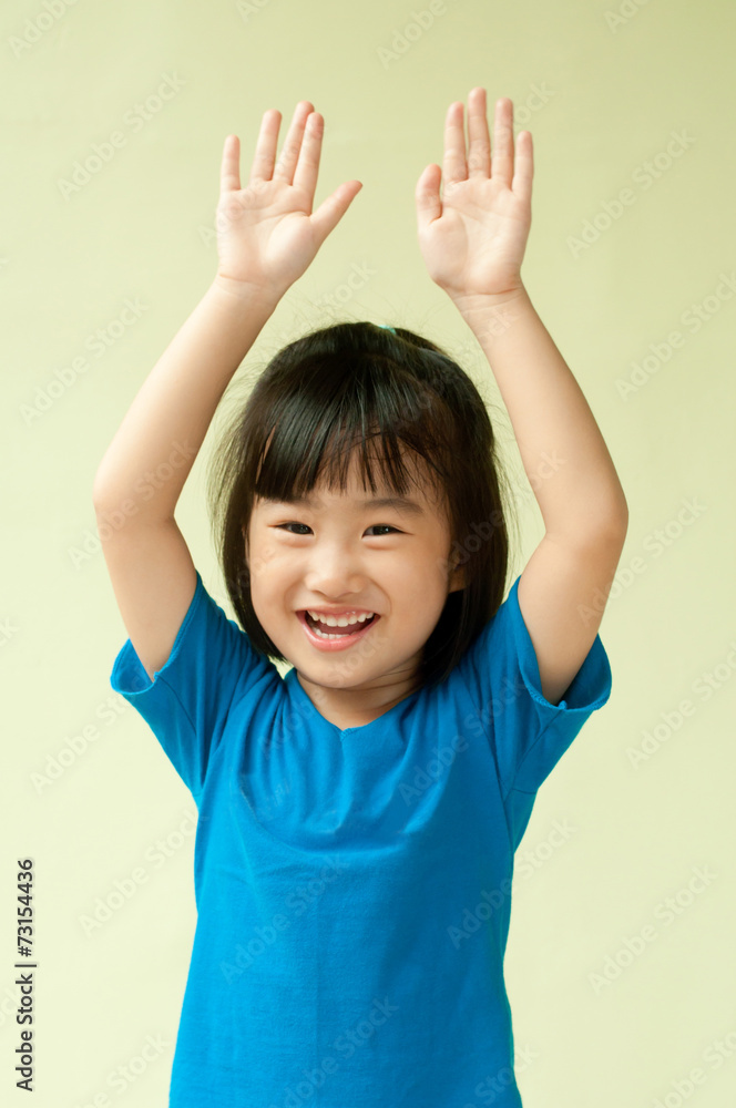 Excited asia little child raising two hand up Excited asia little child raising two hand up