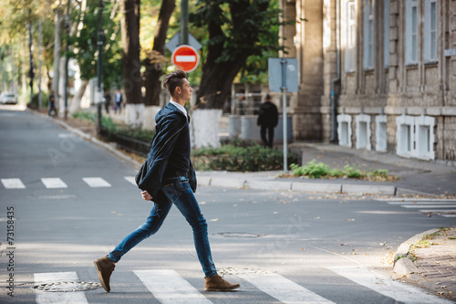 Young man cross the street