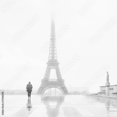 Man and the Eiffel Tower  rain and fog.