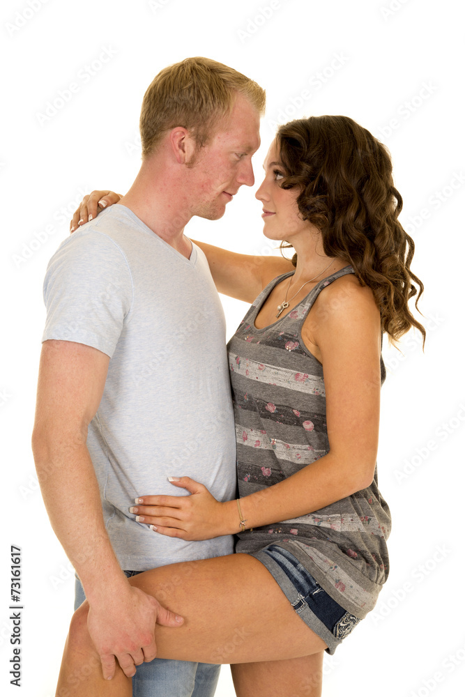 man woman close hold her leg small smiles man woman close hold her leg small smiles