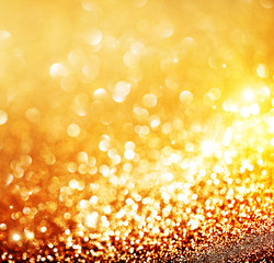 Christmas gold background. Golden holiday glowing background