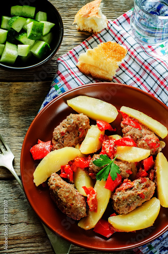 meat cutlets baked with potatoes, tomatoes and red pepper