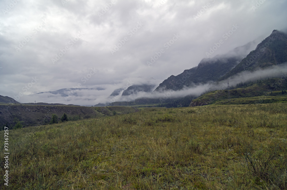 Mountain valley covered with low clouds.