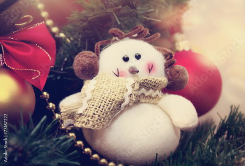 Funny snowman decoration on Christmas tree background © kosobu