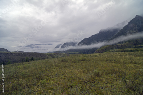 Mountain valley covered with low clouds.