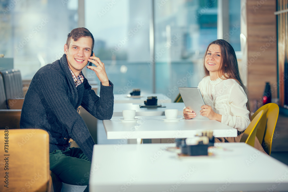 couple in cafe using digital tablet and phone, selective focus couple in cafe using digital tablet and phone, selective focus