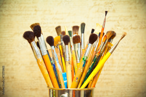 Paint brushes. instrument of the artist. photo toned yellow
