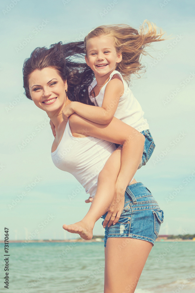 Mother and her daughter having fun on the beach Mother and her daughter having fun on the beach
