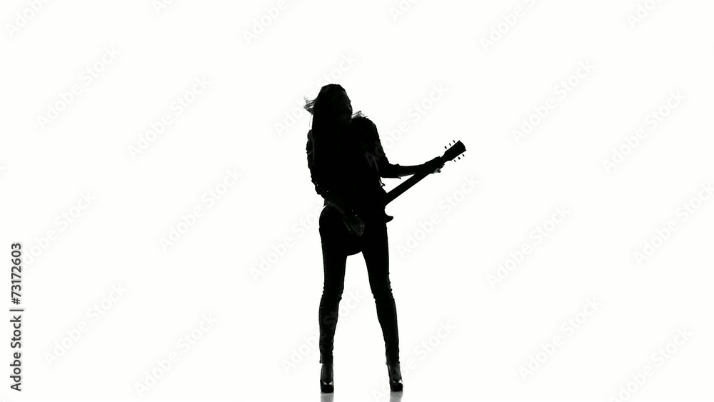 Silhouette of a young girl playing on electric guitar on a white Silhouette of a young girl playing on electric guitar on a white
