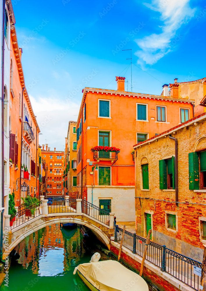 Typical view of a narrow canal with a bridge at Venice Italy