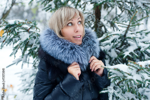 portrait of a girl on the street in winter with snow