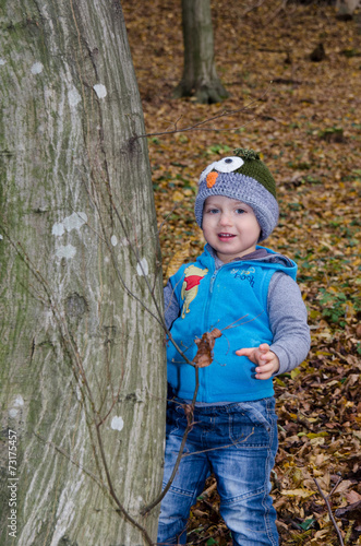 little boy in the woods in autumn