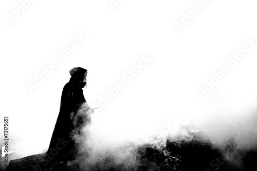 Woman killer holding Japanese sword on apocalyptical landscape photo