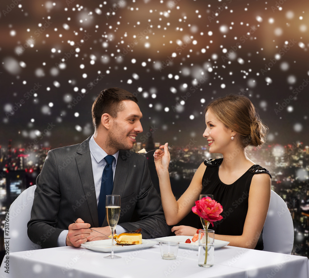 smiling couple eating dessert at restaurant smiling couple eating dessert at restaurant