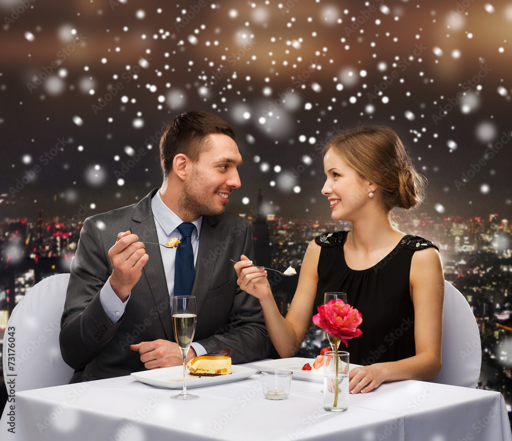 smiling couple eating dessert at restaurant smiling couple eating dessert at restaurant