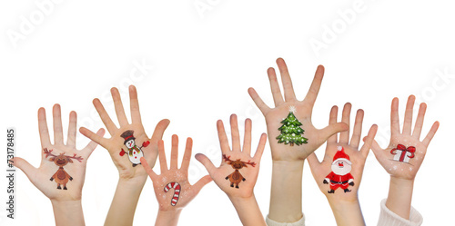 Children's hands raising up with painted Christmas symbols: Sant