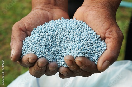hands holding artificial fertilizer photo