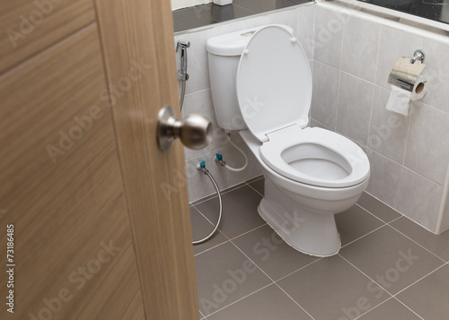 white flush toilet in modern bathroom interior photo